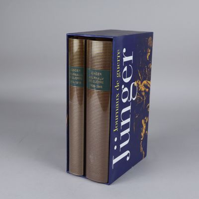 the two books are in a blue box on a white surface