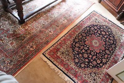 two rugs that are on the floor in the room