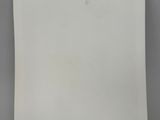 a white piece of paper with a blue label on it