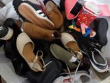 many pairs of shoes that are sitting on a table