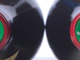 two bottles of wine sitting next to each other on a table