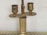 a gold candle holder with two candles on top of it