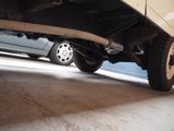 a car that is sitting under a car in a garage