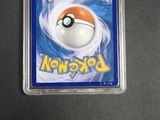 a close up of a pokemon trading card in a plastic case