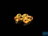 a pair of yellow sapphires sitting on top of a black surface
