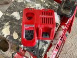a picture of a red corded drill and a hammer on a workbench