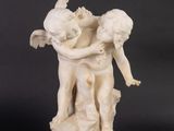 statue of a boy and a girl hugging on a rock