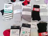 many pairs of socks that are sitting on a table
