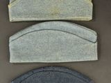 three pieces of felt are lined up on a table