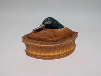 a small bird sitting on top of a box