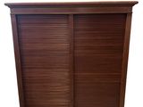 an image of a wooden cabinet with shutters on top of it