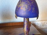 a purple lamp that is sitting on a wooden table
