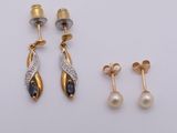 two pairs of earrings and a pair of earrings on a white surface