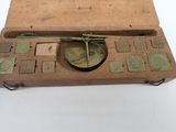 a box with a clock inside of it on a white surface