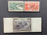 two stamps with a picture of a city on them on a black surface