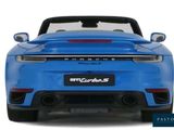 the back of a blue sports car with a white background