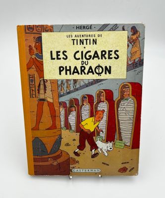 livre pour enfants français, *Les Cigares du Pharaon*, avec l'illustration d'un homme et d'un chien