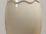 a white vase that is sitting on a table