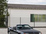 a black car parked in front of a white building