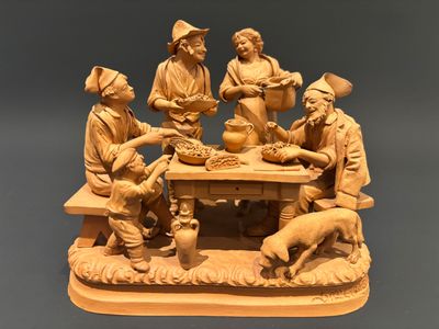 a statue of a group of people sitting around a table