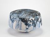 un bol bleu et blanc posé sur une table blanche