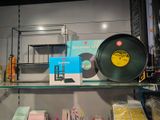 a shelf with a record, a record, and other items on it