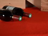 two bottles of wine sitting next to each other on a table