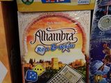 two boxes of board games are stacked on top of each other