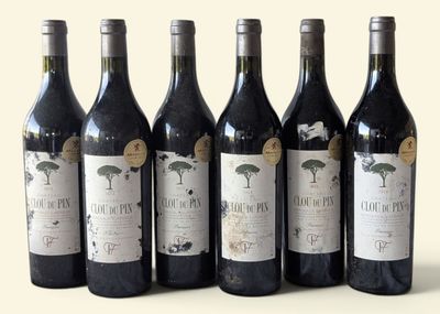 six bottles of wine are lined up in a row on a table