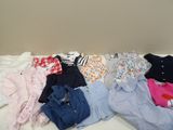a lot of clothes that are on a bed