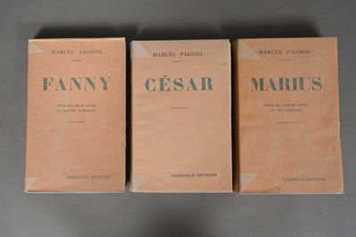 three boxes of perfume sitting on top of a table next to each other