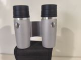 a close up of a pair of binoculars sitting on top of a bag