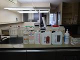 many bottles of liquid sitting on the counter in the kitchen