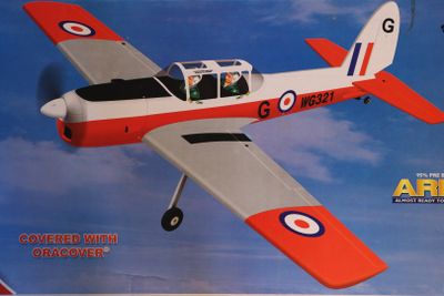 a red and white airplane with a man in the cockpit