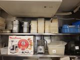 many plates and containers on the shelves in the kitchen