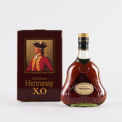 the bottle of hennessy xo is next to the box
