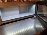 stainless steel counter top in a restaurant with a glass door