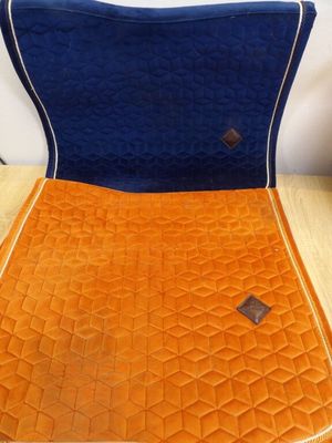 an orange and blue chair cushion on a wooden table