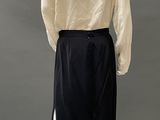 an image of a mannequin wearing a white shirt and black skirt