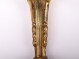 a gold vase with a clock on top of it