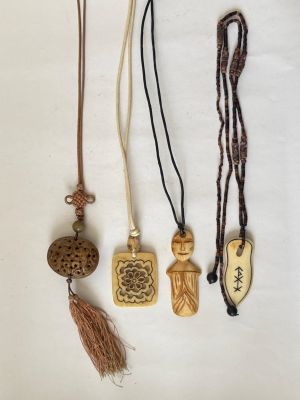 several different types of necklaces are displayed on a white surface
