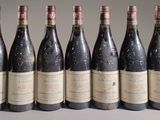 six bottles of wine are lined up in a row on a table