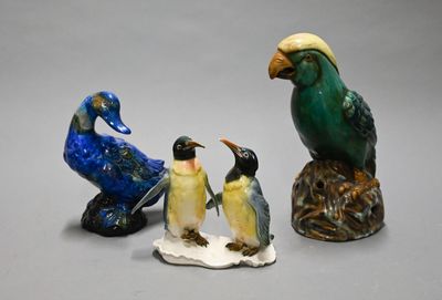 three figurines of birds sitting on top of each other
