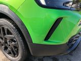 a close up of the front bumper of a green car