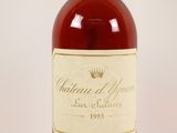 a close up of a bottle of wine on a white surface