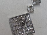 silver plated pendant with a picture of a man and a woman in a kitchen