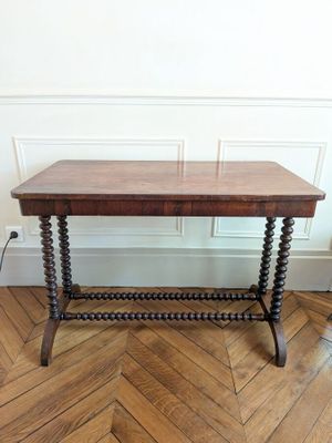 an old wooden table sitting on top of a hard wood floor