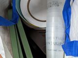 a white bag with a blue ribbon and a bottle of wine