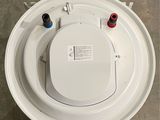 an overhead view of a white toilet with two red and one blue knobs