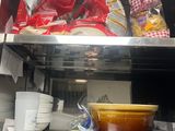 a metal shelf with bowls, plates, and bowls on it